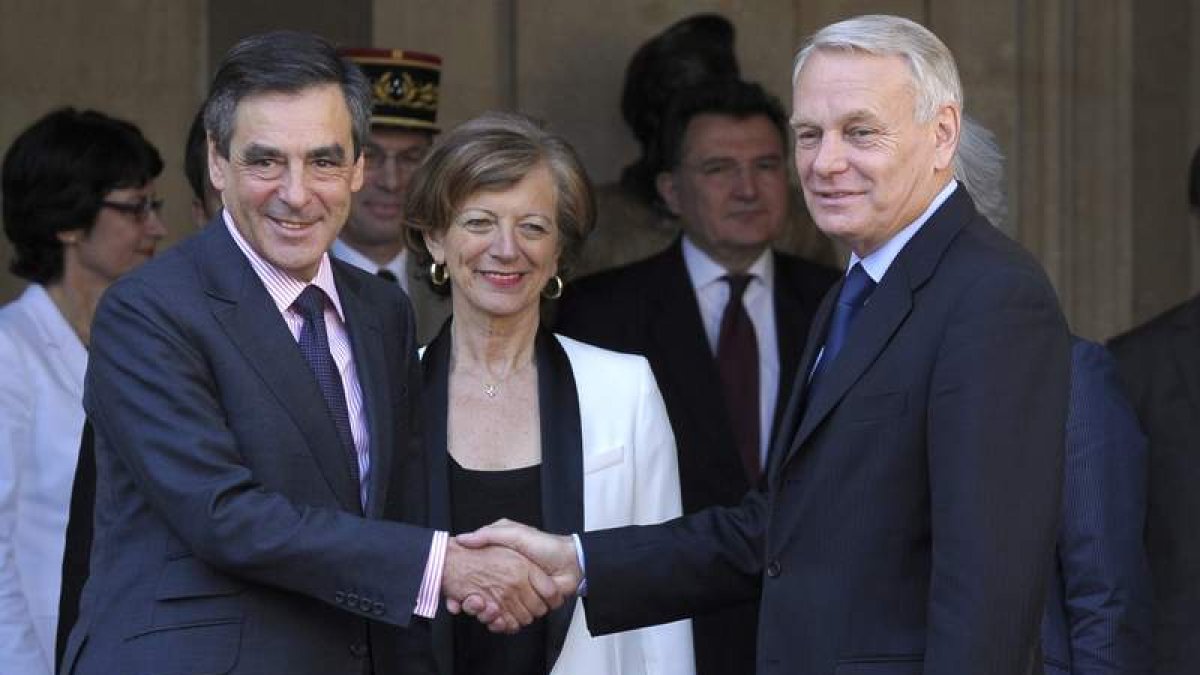 El antiguo primer ministro francés saluda al que ocupará su cargo, Jean-Marc Ayrault.