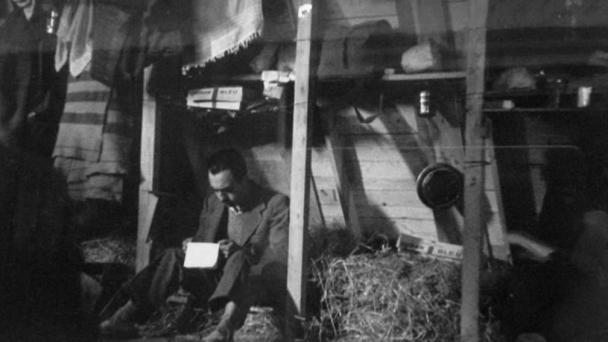 Un refugiado lee una carta en su cubículo