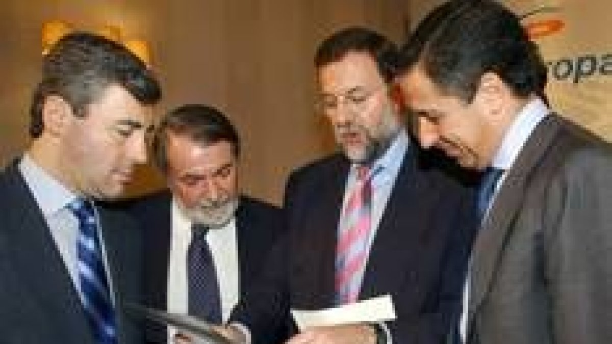 Mariano Rajoy conversa con Eduardo Zaplana, Jaime Mayor Oreja y Ángel Acebes, ayer, en Santiago