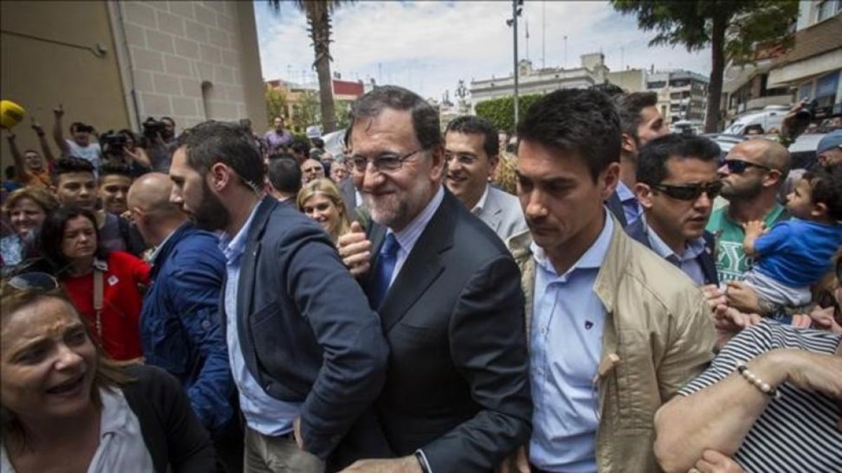 El presidente del Gobierno en funciones, Mariano Rajoy, increpado a su llegada al municipio valenciano de Alfafar.