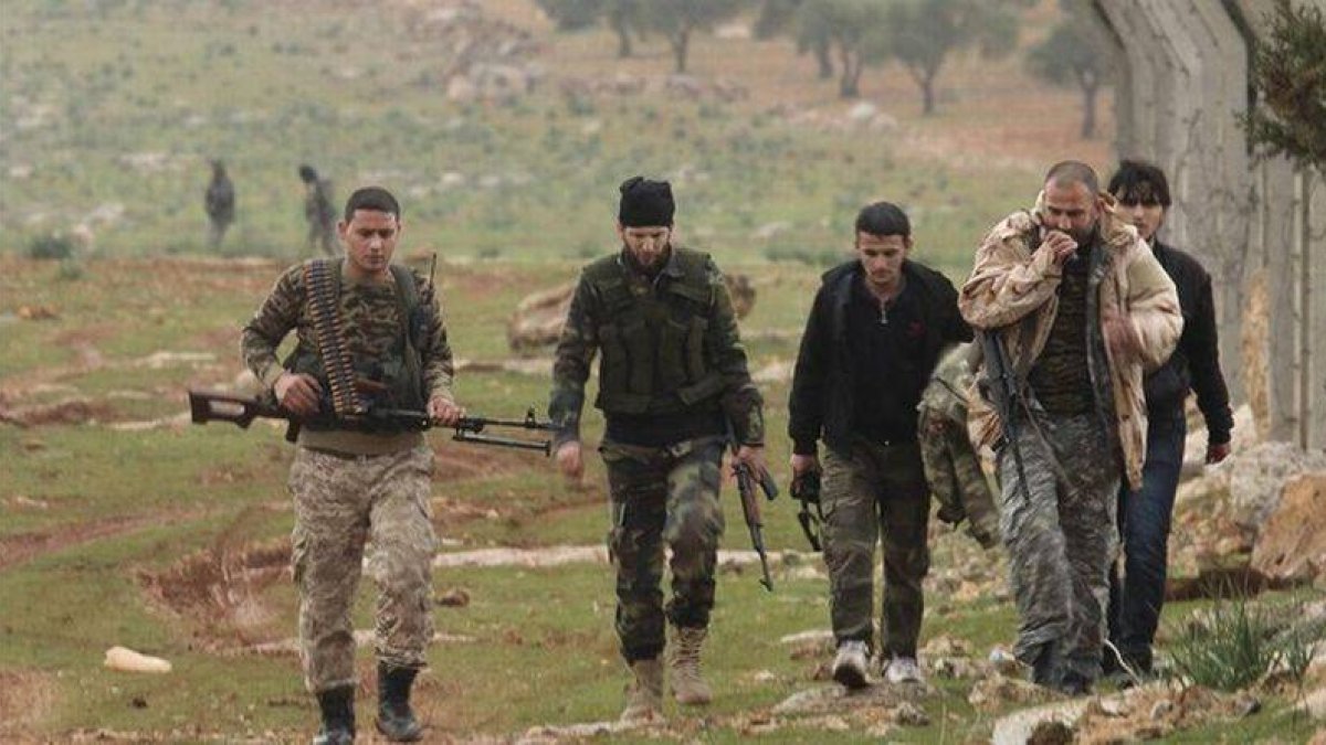 Rebeldes sirios se dirigen a la línea de frente en Ratian, al norte de Alepo, este martes.