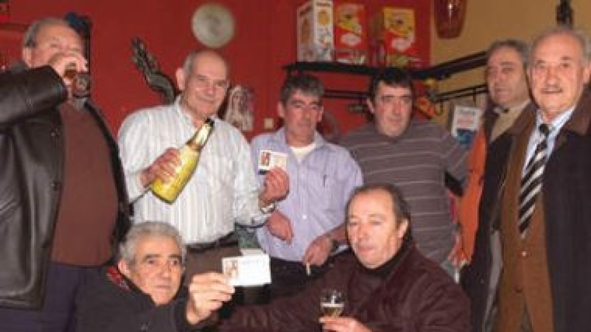 Vecinos y agraciados brindan en el bar de Villavelasco por el premio por aproximación que les llegó