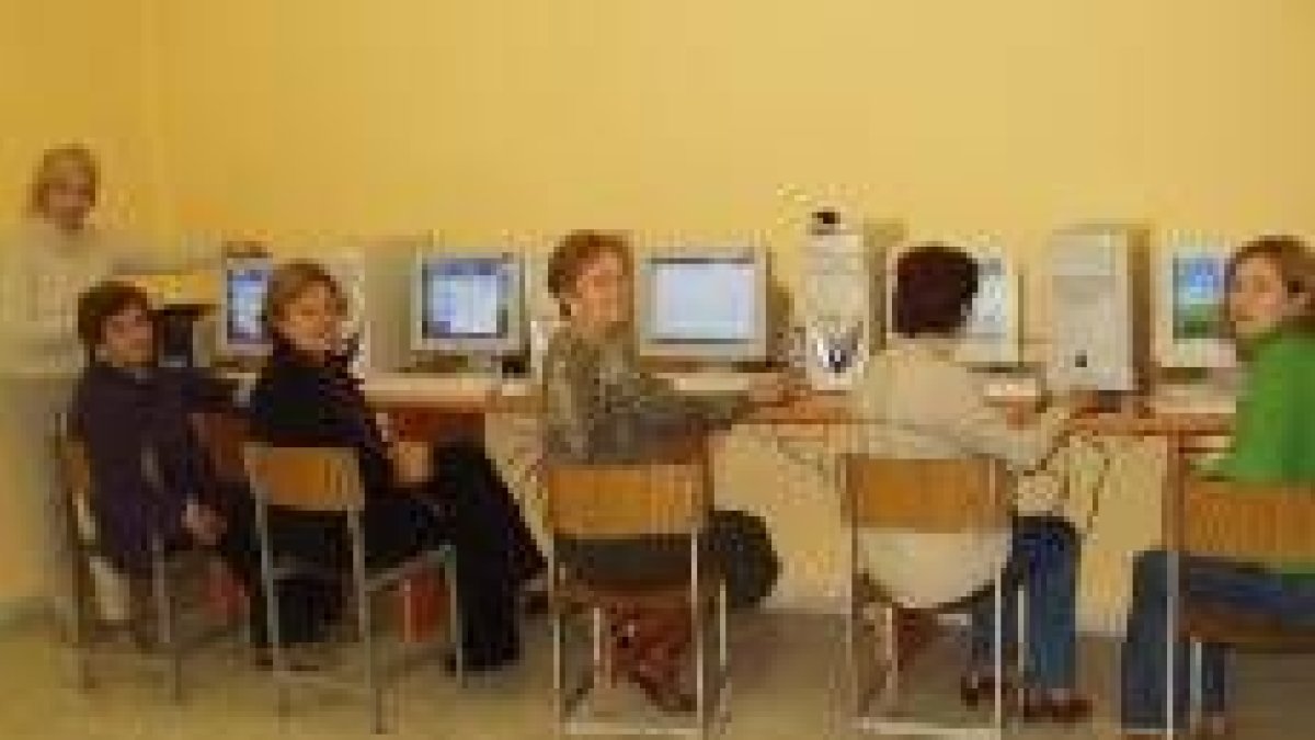 Varias alumnas del aula de adultos en la nueva sala de alfabetización digital