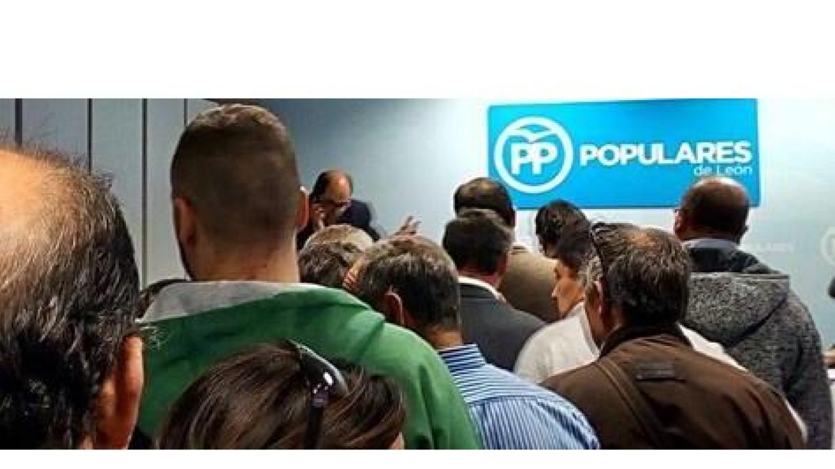 Cola para votar en la sede provincial del PP en León. Al fonso, al teléfono, uno de los interventores de Mañueco. DL