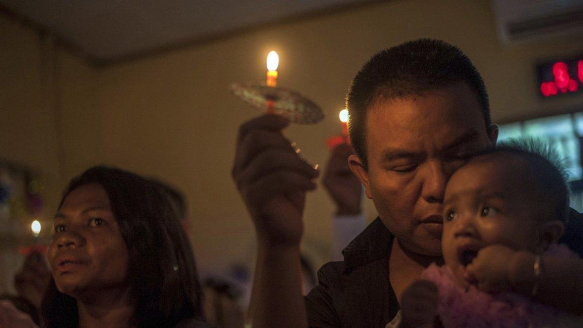 People attend a Christmas service at Rahmat Pentecostal Church in Carita  Indonesia  Christmas celebrations traditionally filled with laughter and uplifting music were replaced by somber prayers for tsunami victims in Indonesia