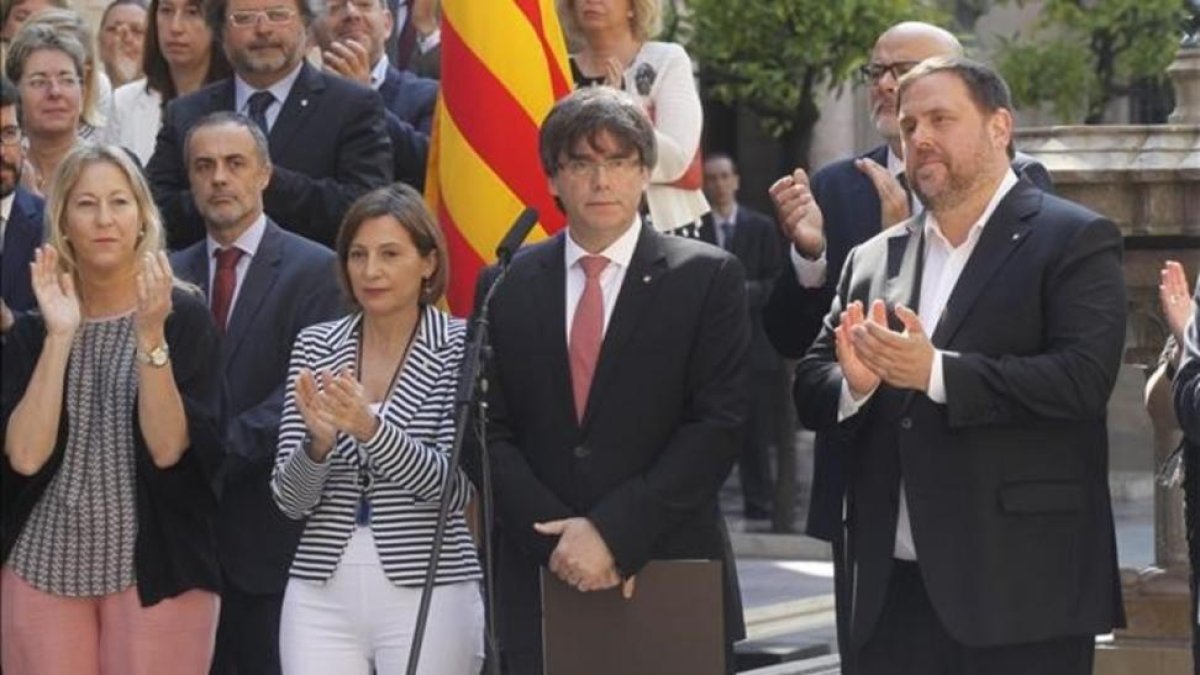 El 'president', Carles Puigdemont, y el vicepresidente del Govern, Oriol Junqueras, durante el anuncio de la fecha y la pregunta del referéndum.
