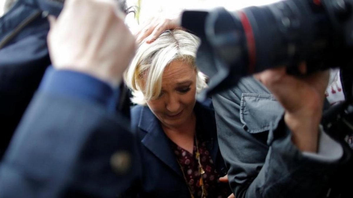 Marine Le Pen, protegida por sus guardaespaldas del lanzamiento de huevos.