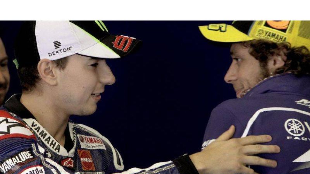 Los pilotos Jorge Lorenzo y Valentino Rossi conversan en su box en la segunda jornada de los entrenamientos oficiales en Jerez.