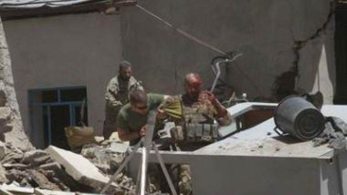 Soldados de la Otan ayudan a un compañero herido en el atentado.
