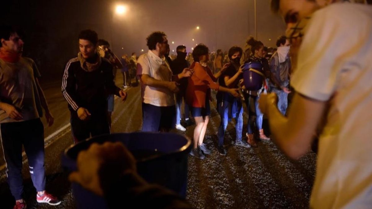 Un grupo de personas combate el fuego con cubos de agua en las afueras de Vigo.