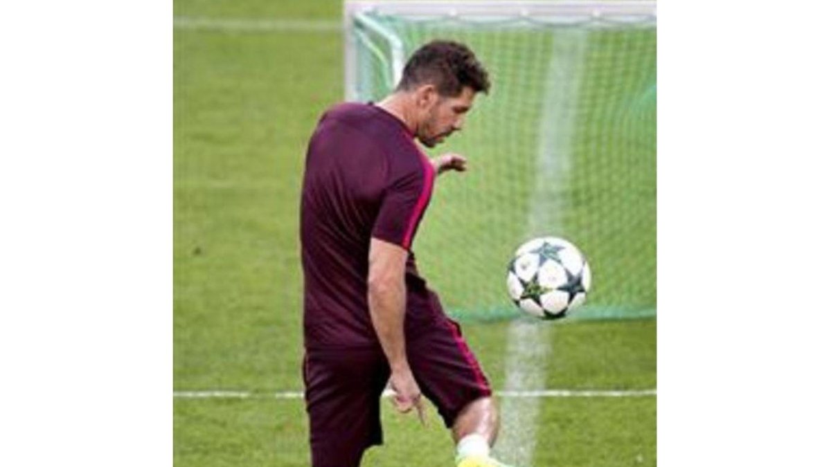 Un futbolista juega con un balón.