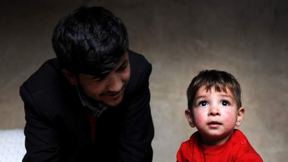 Sayed Asadullah se sienta junto a su hijo, llamado Donald Trump, en Kabul.