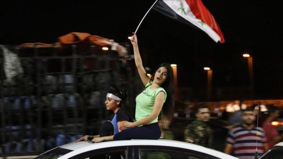 Aficionados sirios celebran el empate ante Irán.