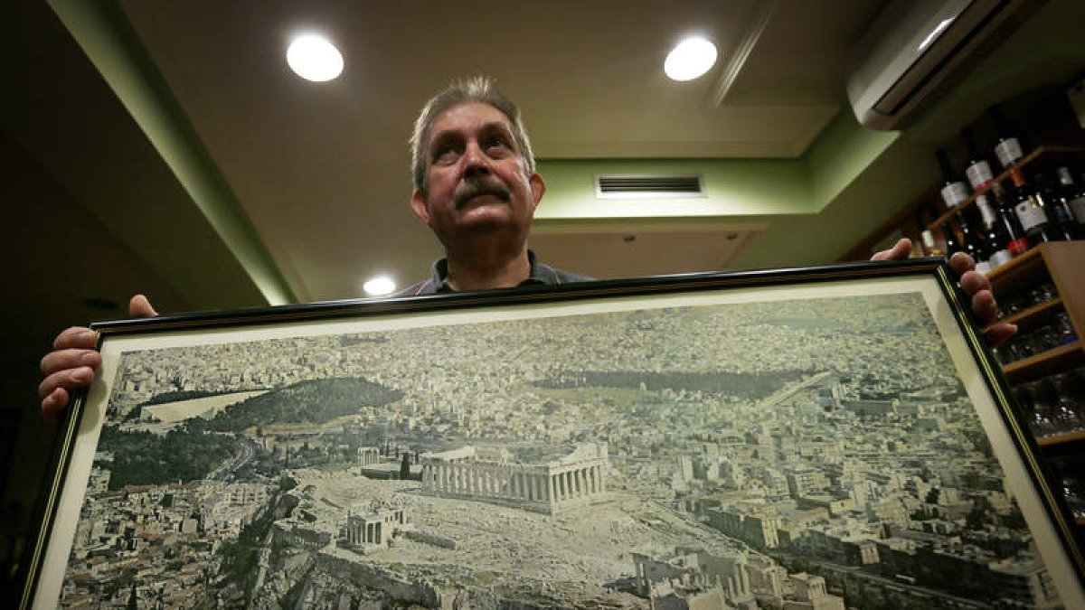 Theófanis Ougiaros, ayer en su restaurante con una fotografía de Grecia .