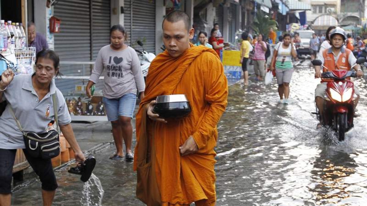 Un monje atraviesa las calles inundadas de Bangkok.