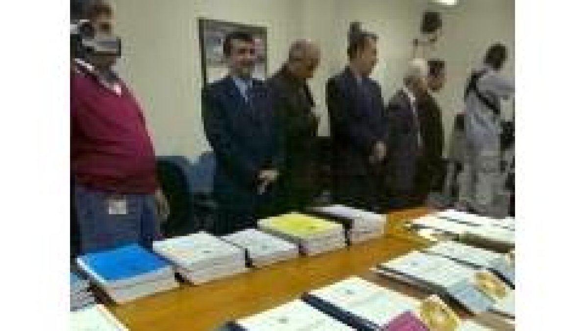 Funcionarios iraquíes muestran los diversos tomos del informe