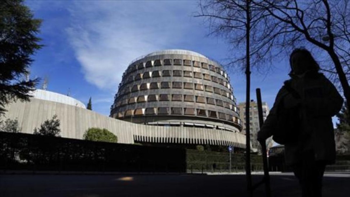 Una transeúnte pasa junto a la sede del Tribunal Constitucional, en Madrid.