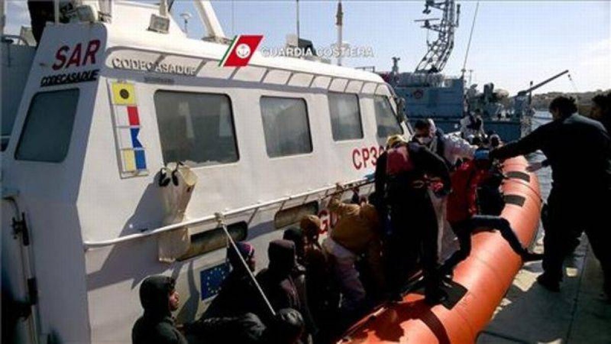 Un grupo de inmigrantes llegando al puerto de Lampedusa tras ser rescatados por la Guardia Costera en el mar Mediterráneo, entre Libia e Italia.