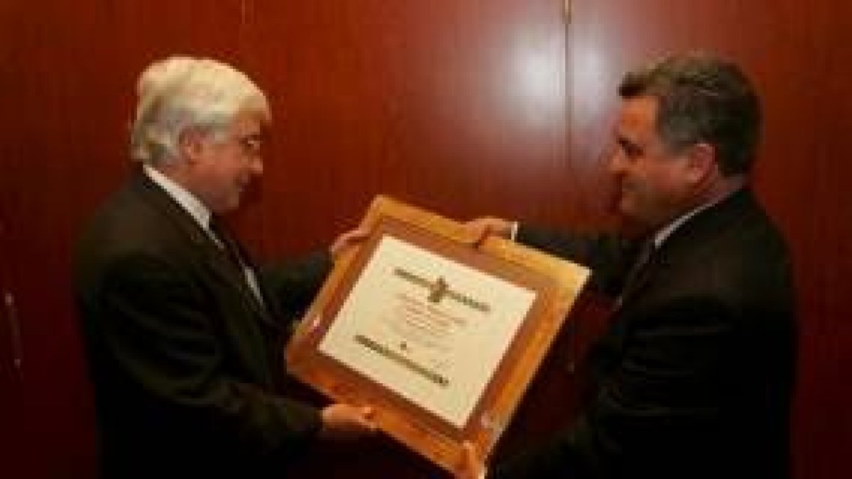 El presidente de la asociación entrega el diploma a Romero (izquierda)