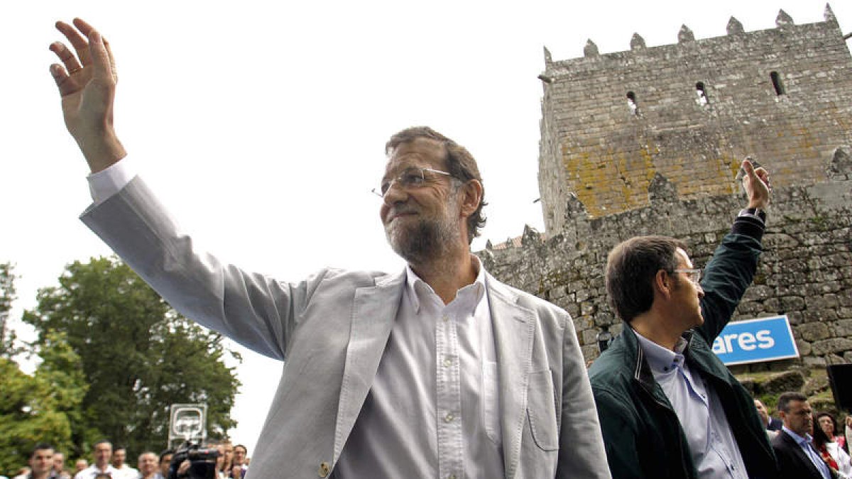 Rajoy y Alberto Núñez Feijóo saludan a los asistentes durante el acto de ayer.