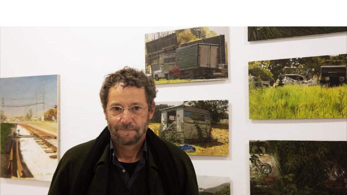 El artista leonés Félix de la Concha posa junto a algunas de las obras que expone en la galería Ármaga. CUEVAS