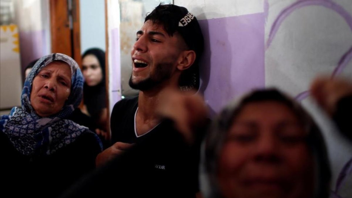 Palestinos, desgarrados por el dolor tras la muerte de unos familiares.