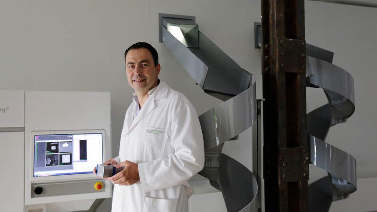El farmacéuticoi Fernando Álvarez muestra la sección del robot que sirve para el almacenamiento automático de medicamentos y las dos líneas de salida.