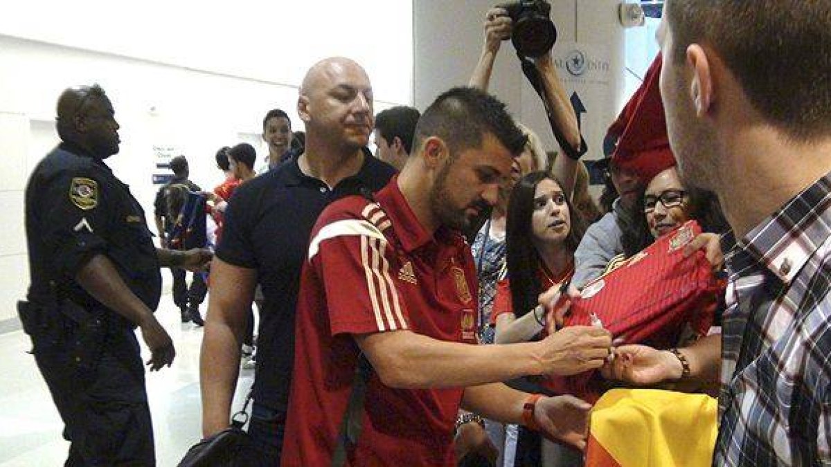 Decenas de aficionados dan la bienvenida a los jugadores de la selección española en el aeropuerto de Baltimore-Washington.