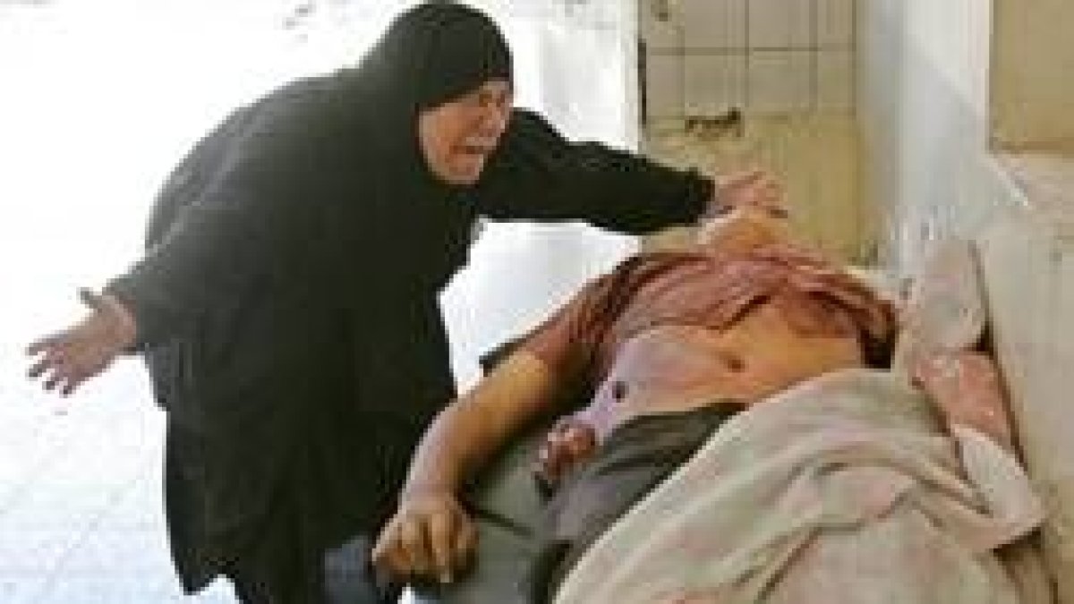 La madre de Samah Hussein llora ante el cadáver de su hijo, muerto en el atentado de ayer en Bagdad