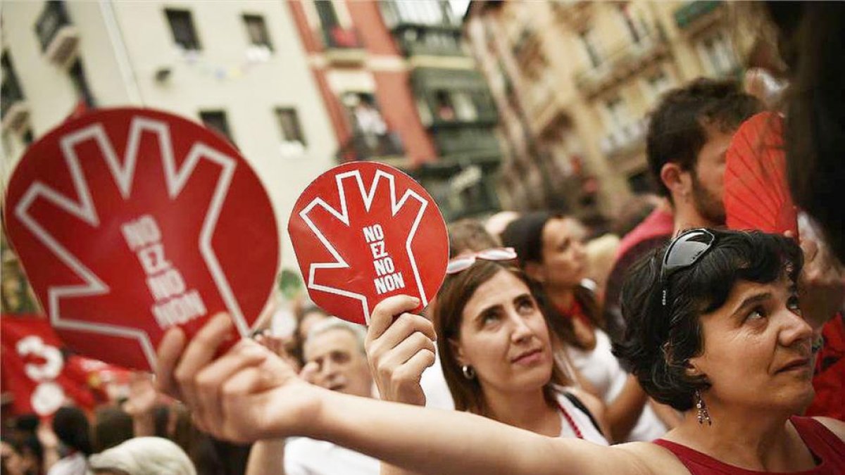 Unas mujeres muestran el símbolo de la campaña contra las agresiones sexistas en Sanfermines durante la manifestación ciudadana.