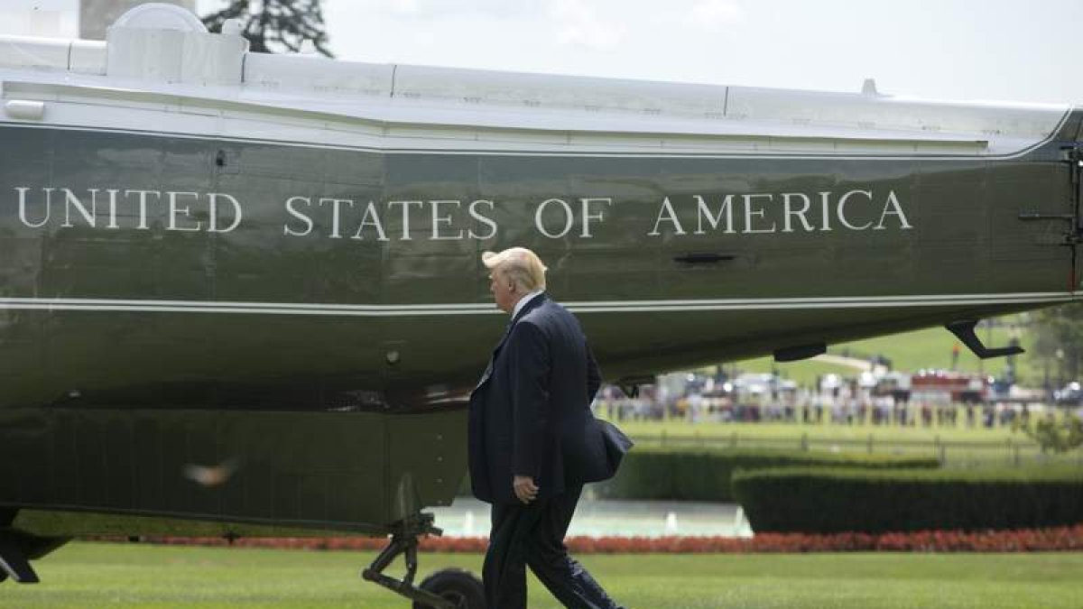 Trump camina por el jardín de la Casa Blanca antes de subir al helicóptero presidencial. M. REYNOLDS
