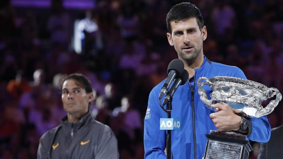 Djokovic con su trofeo tras superar a un Nadal que lo mira de reojo tras ceder frente al serbio en su peor partido del torneo. RITCHIE TONGO