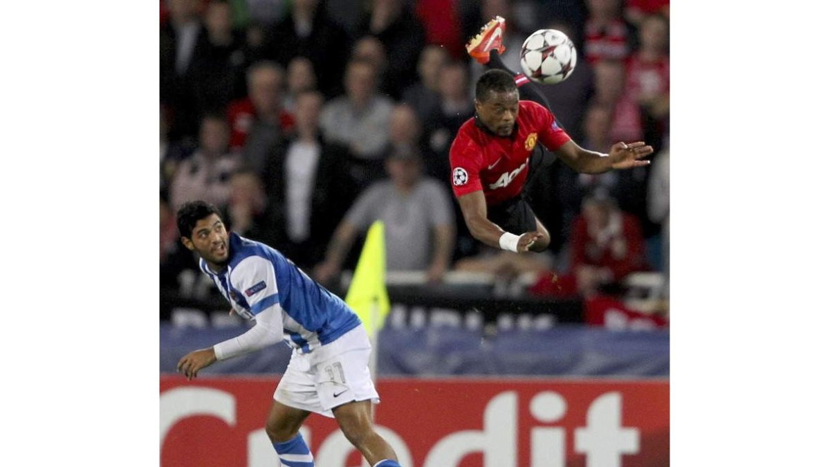 Carlos Vela, izquierda, lucha con el defensa Rio Ferdinand.