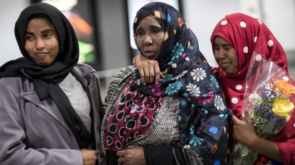 Dos hermanas somalís a las que denegaron el acceso a EEUU tras el veto migratorio de Trump son recibidas por su madre en el aeropuerto de Chantilly, Virginia.