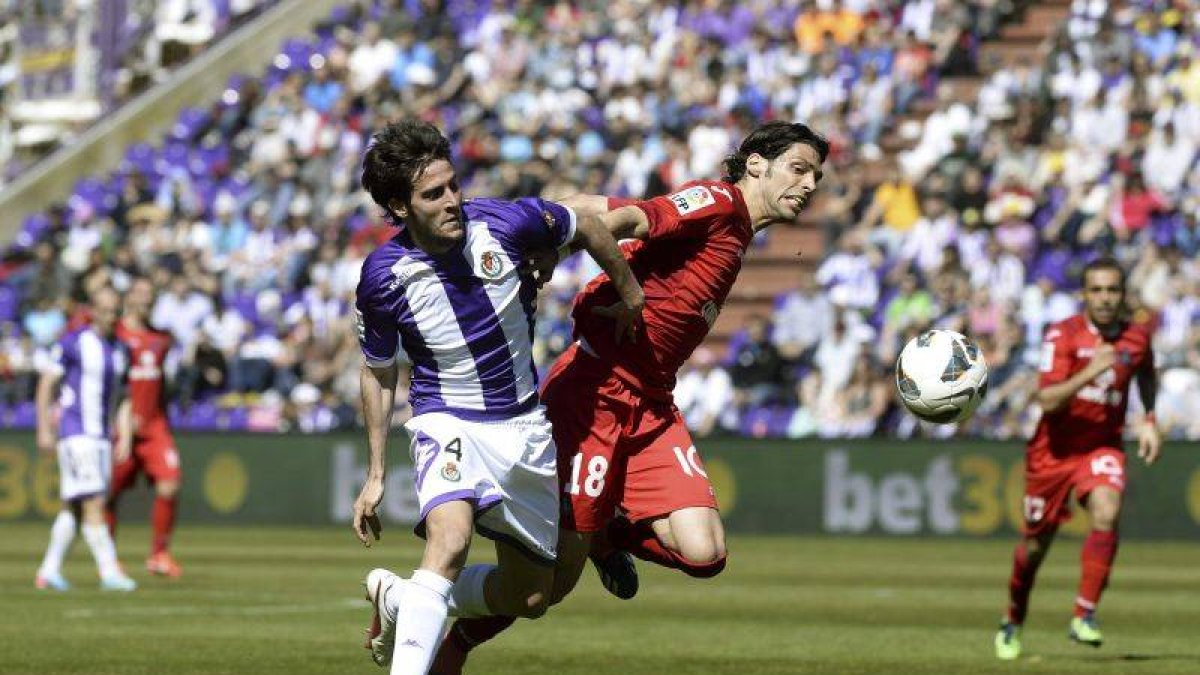 El centrocampista del Getafe Ángel Lafita pugna por el balón con el defensa del Real Valladolid Marc Valiente durante el encuentro disputado en en el estadio José Zorrilla.