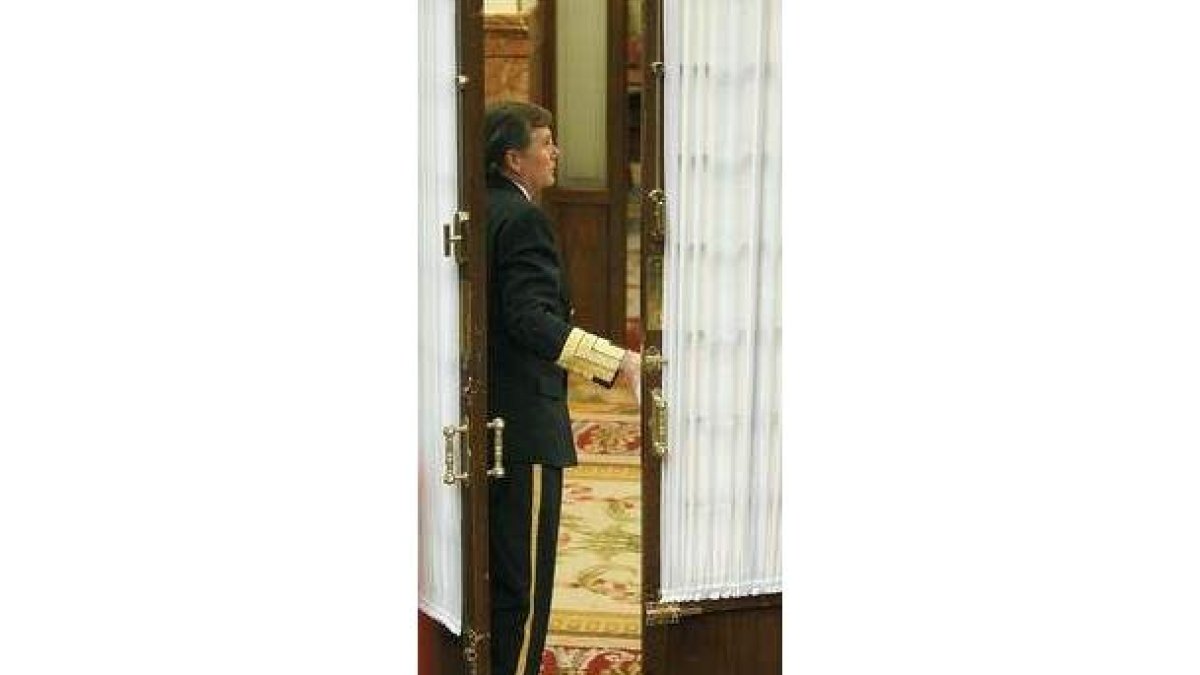 Un ujier cierra una puerta del Congreso.
