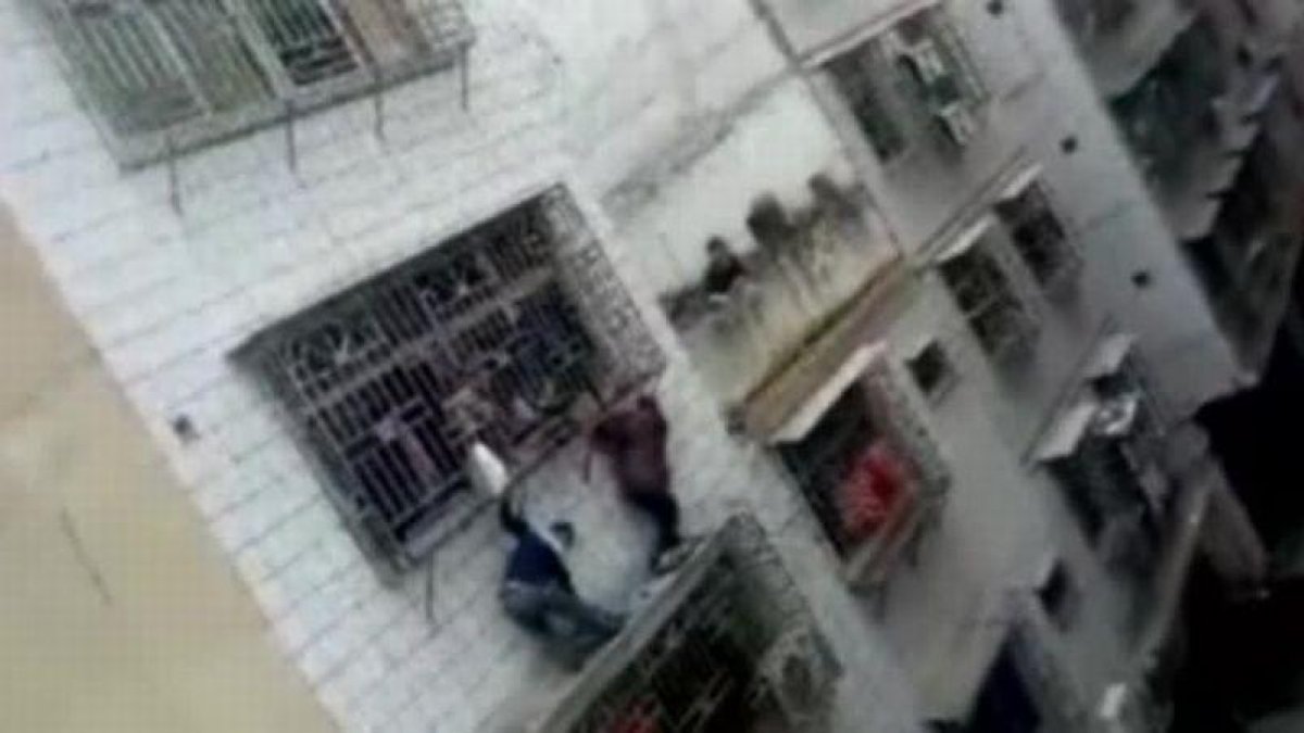 Rescatada una niña en China que se había quedado colgada de un balcón.