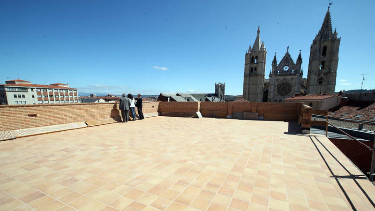 Excepcional vista de la ciudad  desde la terraza del edificio, con la Catedral al fondo. Sobre estas líneas, una vidriera que se restaurará tras ser retirada la ventana y un detalle de una de las columnas de hierro que se reparten por el interior del edif