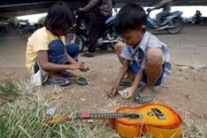 Dos niños indonesios, de ocho y diez años, cuentan su dinero en una calle de Yakarta