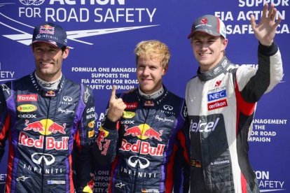 Mark Webber y Sebastian Vettel celebran que Red Bull ha copado la primera línea de la parrilla del GP de Italia, hoy, en Monza.