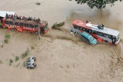 Decenas de personas se refugian de las aguas en los techos de autobuses