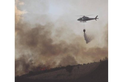 Descarga de agua de un helicóptero, el sábado en Moreda.