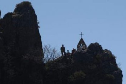 La ermita de Valdorria, arriba en la peña, y el pueblo en una peregrinación. En la foto pequeña, la