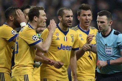 Los jugadores de la Juventus rodean al árbitro tras el polémico penalti.