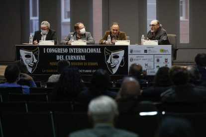 A la izquierda, la mesa redonda de la tarde de ayer; y a la derecha, mascarado de cinco metros representando a un Jurru de Alija que será quemado hoy. FERNANDO OTERO