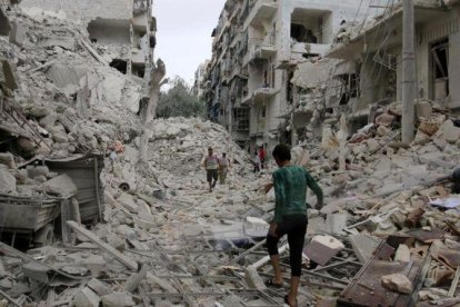 Varias personas inspeccionan los daños tras los bombardeos sobre el barrio de Tariq al-Bab, en manos rebeldes, en Alepo, este viernes.