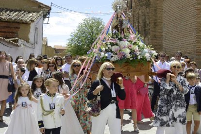 Momento en el que los vecinos acompañan a la virgen hasta su ermita, a la izquierda, y misa en la que los niños y niñas van vestidos de comunión, a la derecha. ACACIO