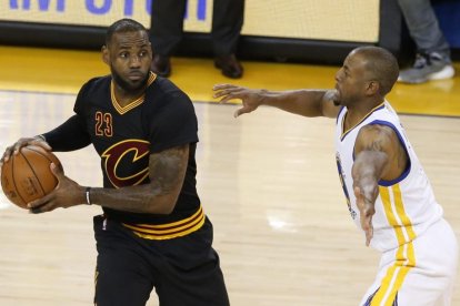 LeBron James trata de supera a Andre Iguodala, en el quinto partido de las finales de la NBA entre Cavaliers y Warriors, el lunes en Oakland.