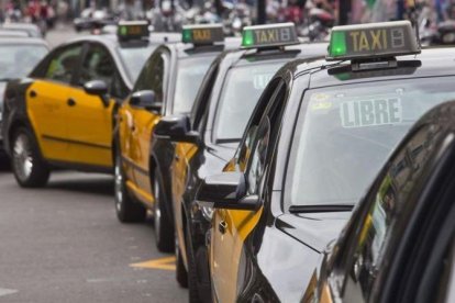 Taxis esperan en Plaza Catalunya.