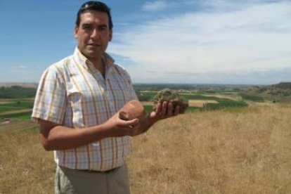 El alcalde de Villasabariego, Jesús García, sujeta restos de un asentamiento en Valle de Mansilla